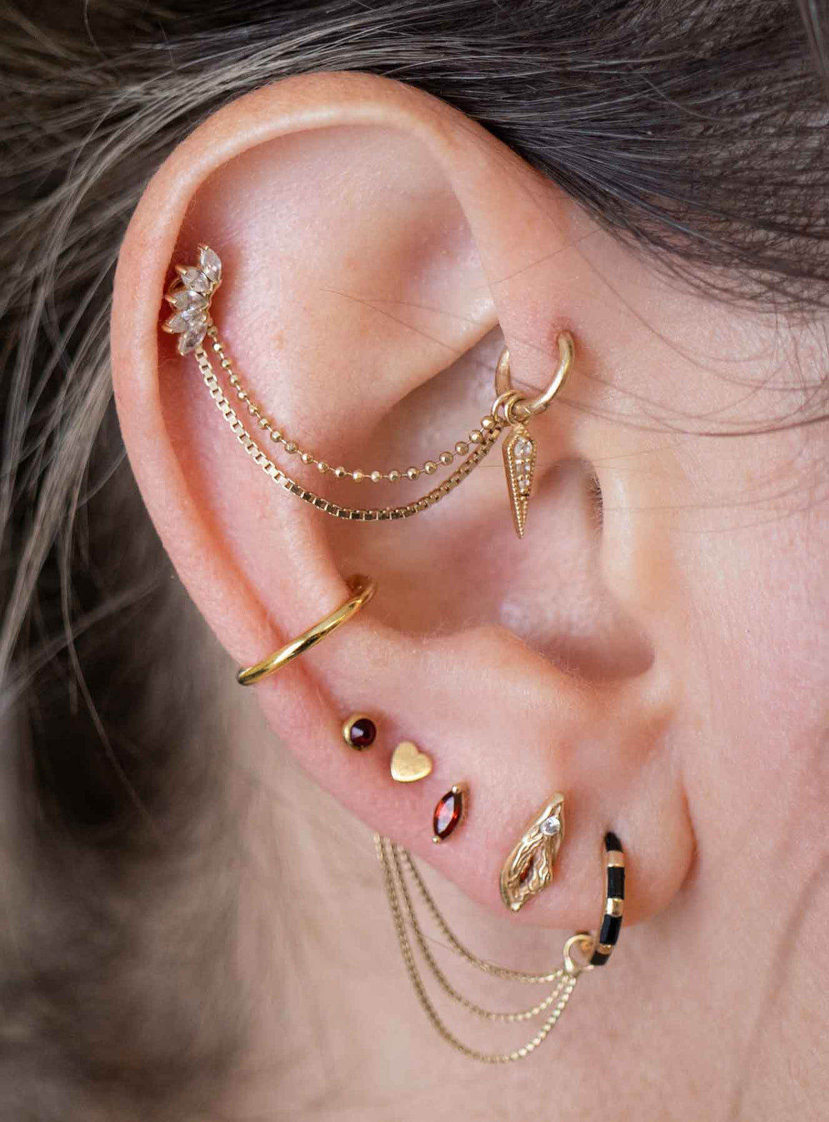 yellow gold curated earscape with chains and cuffs